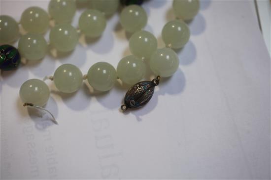 A celadon jade and two colour enamel bead necklace with carved jade pendant, 32in.